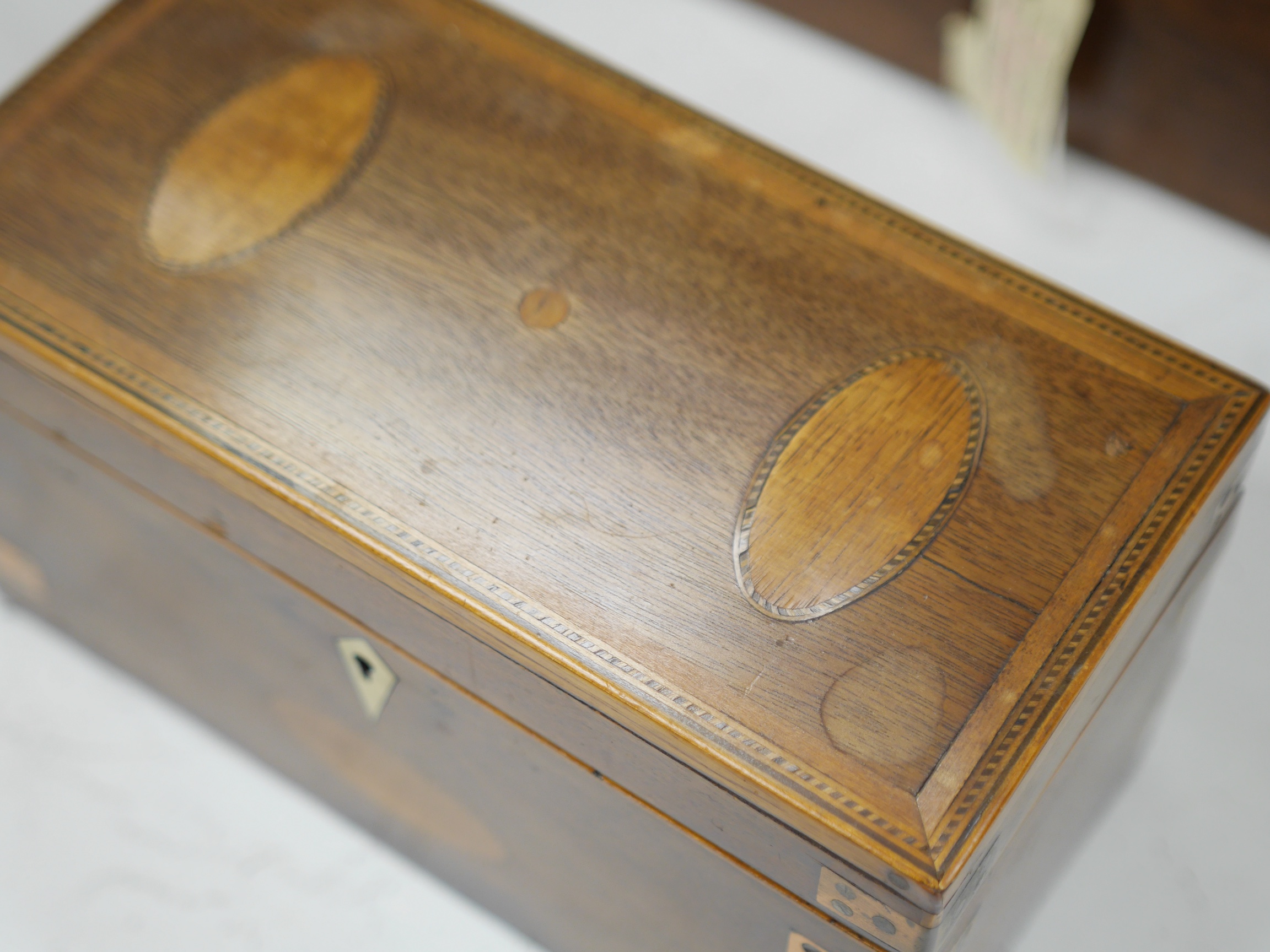 An early 19th century inlaid tea caddy, two sewing boxes and a stationery box, 25.5cm x 14cm various. Condition - stationery box good, others have some damage